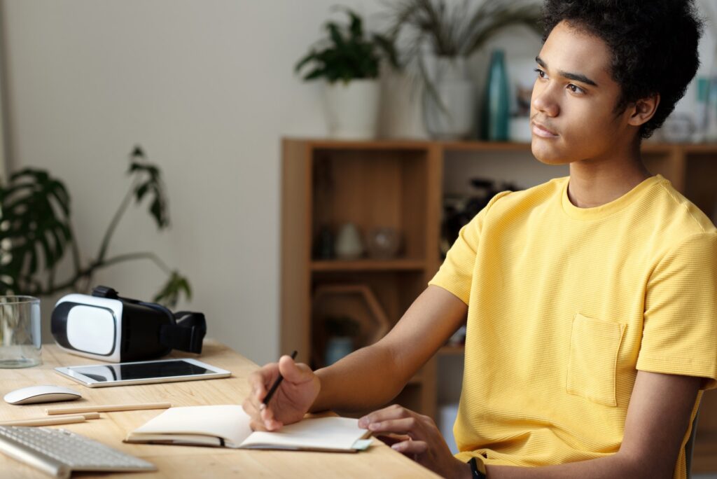 Student deep in thought, preparing for an exam, poised with pen over diary, ready to jot down motivational insights!