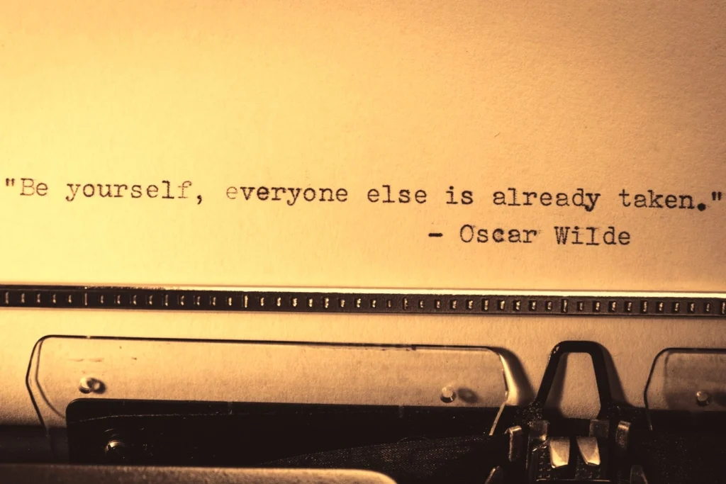 An image of a typewriter text with a funny inspirational quote by Oscar Wilde